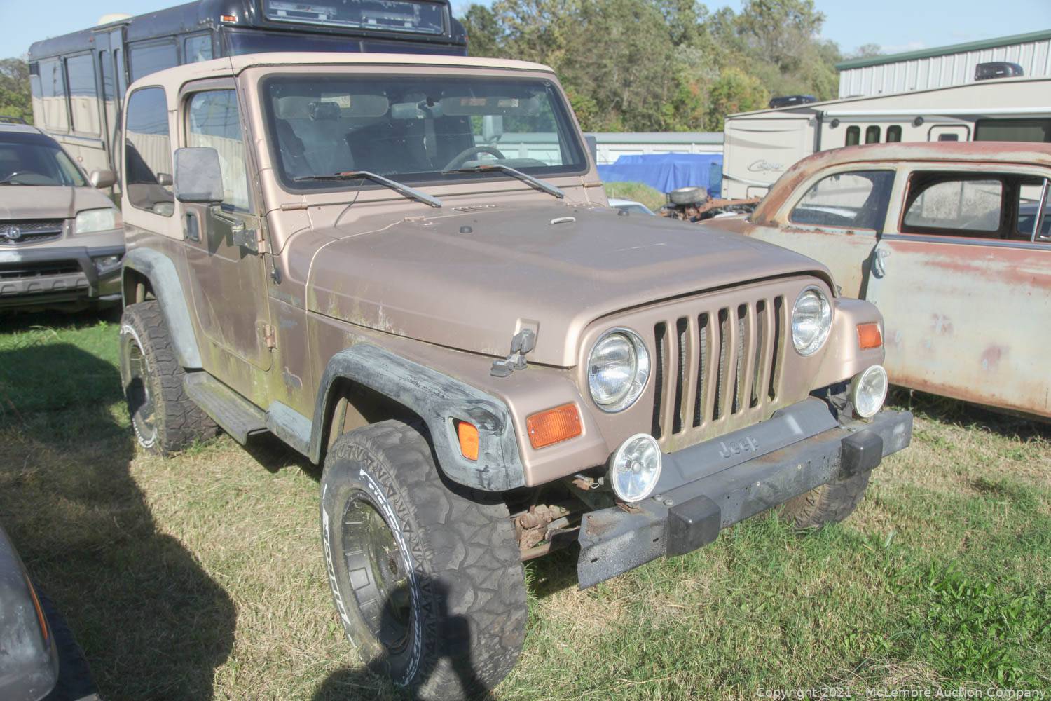 McLemore Auction Company - Auction: Four Classic Jeeps Including a 1990  Custom Wrangler with LS Swap ITEM: 1998 Gold Jeep Wrangler  5sp VIN  1J4FY1959XP486996